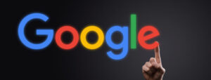 Quality-Score-on-google-ads-businessman-suit-dark-background-holds-google-logo-inscription-google-is-world-s-most-popular-search-engine